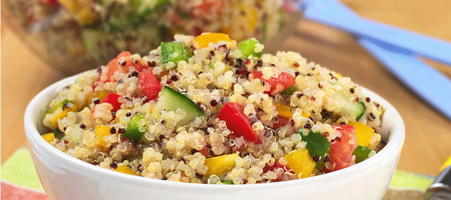 Bowl of cooked quinoa mixed with vegetables